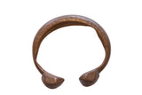 Antique African bronze snake cuff bracelet with an aged patina and etched surface patterns.