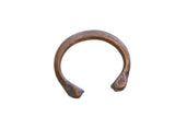 Antique African copper cuff bracelet with a snake design, etched details, and a time-worn patina.