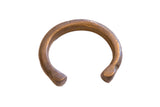 Antique African copper alloy cuff bracelet with etched snake-like patterns and a warm patina.
