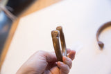 Detail of the hand-stamped pattern and warm patina on the antique copper snake cuff.