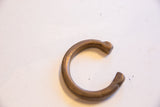 Overhead view of the antique copper snake cuff showing its etched terminal and warm aged patina.