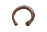 Antique African bronze snake cuff bracelet with an incised, textured body and dark patina.