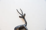 Vintage African gazelle figurine's dark metal head with textured, ribbed horns.
