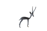 Vintage right-facing African gazelle table accent with a slender, stylized form and dark finish.