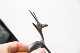 Aged metal patina and sculpted details on the vintage gazelle's head and horns.