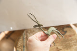 Vintage African gazelle held in hand to show its small scale and aged patina.