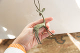 Side view of the vintage gazelle's body, highlighting its greenish oxidized texture.