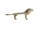 Vintage African lion figurine with an elongated body and a mottled, oxidized patina.