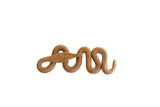 Vintage African iron snake with a textured rust patina in a serpentine coil.
