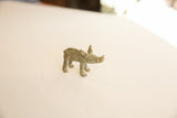 Vintage African bronze boar showing its side profile, textured spine, and aged patina.