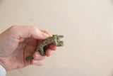 Detailed profile view of the vintage African pangolin sculpture's textured scales.