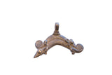 Vintage African pendant with a symmetrical animal motif and textured, aged bronze-tone finish.