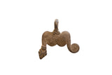 Vintage African pendant in aged brown metal with incised texture and an asymmetrical spiral arm.