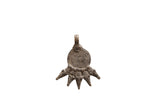 Vintage African pendant in aged metal with an incised spiral and five-pointed base.