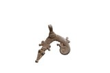 Vintage African metal pendant in a stylized lizard shape with etched patterns and a curled tail.