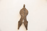 Reverse side of the vintage African pendant showing its coarse, hand-worked texture.