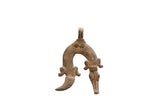 Vintage African pendant with an arched shape, textured bronze patina, and stylized animal heads.
