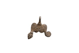 Vintage African pendant with a dark, aged patina and stylized scroll and carved details.
