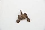 Reverse side of the vintage African pendant, showing its textured, rustic surface.