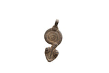 Vintage African pendant in weathered dark metal with an incised spiral design.