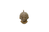 Vintage African bronze face pendant with stylized features and a textured, aged finish.