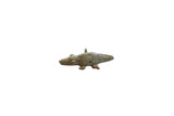 Vintage African bronze crocodile pendant with etched spiral details and an aged patina.