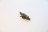 Profile view of the vintage bronze crocodile pendant showing its textured body and patina.