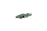 Vintage African bronze crocodile pendant with a textured body and aged green patina.