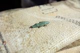 Angled perspective of the vintage bronze crocodile pendant highlighting its texture.