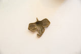 The hollowed reverse of the vintage bronze elephant pendant showing its aged patina.
