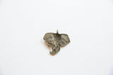 Reverse view of the vintage African elephant pendant showing its aged bronze texture.