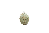 Vintage African bronze face pendant with a textured headdress and green patina.