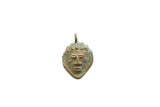 Vintage African bronze face pendant with stylized features and a weathered patina.