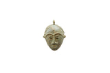 Vintage African bronze face pendant with a decorative braided headband and aged patina.