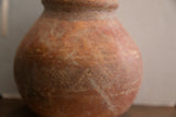 Surface detail of the antique red slip ware vase showing its storied patina.