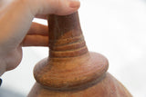 Close-up of the handmade rings and antique texture on a red slip ware vase neck.