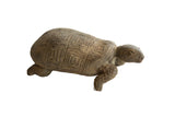 Vintage African tortoise sculpture with a rustic, earthy texture and a carved geometric shell.