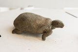 Left profile of the vintage tortoise sculpture showing hand-carved geometric shell patterns.