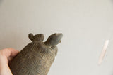 Profile view showing the carved shell and smooth head of the vintage tortoise figure.