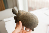 Vintage tortoise sculpture held in hand, showing scale and textured, geometric shell.