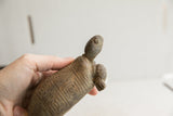 Close view of the vintage African tortoise sculpture's weathered head and neck.