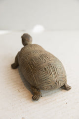 Angled rear view of the vintage tortoise sculpture's carved geometric shell.