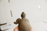 Back view of the vintage tortoise sculpture with its head angled upwards.