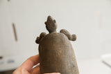 Detailed upward view of the vintage tortoise sculpture's textured head and shell.