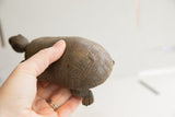 Vintage African tortoise sculpture held in hand to demonstrate its size and carved texture.