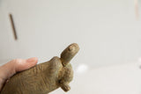 Profile view of the vintage tortoise sculpture's head showing its aged patina.