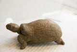 Side profile of the vintage African tortoise sculpture showing its textured body.