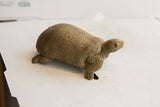 Vintage tortoise sculpture showing the rustic, hand-carved texture and geometric shell pattern.