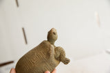 Close-up of the African tortoise sculpture's head gazing upward, showing handmade texture.