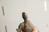 Close-up profile of the vintage tortoise sculpture's head, showing carved features and aged texture.